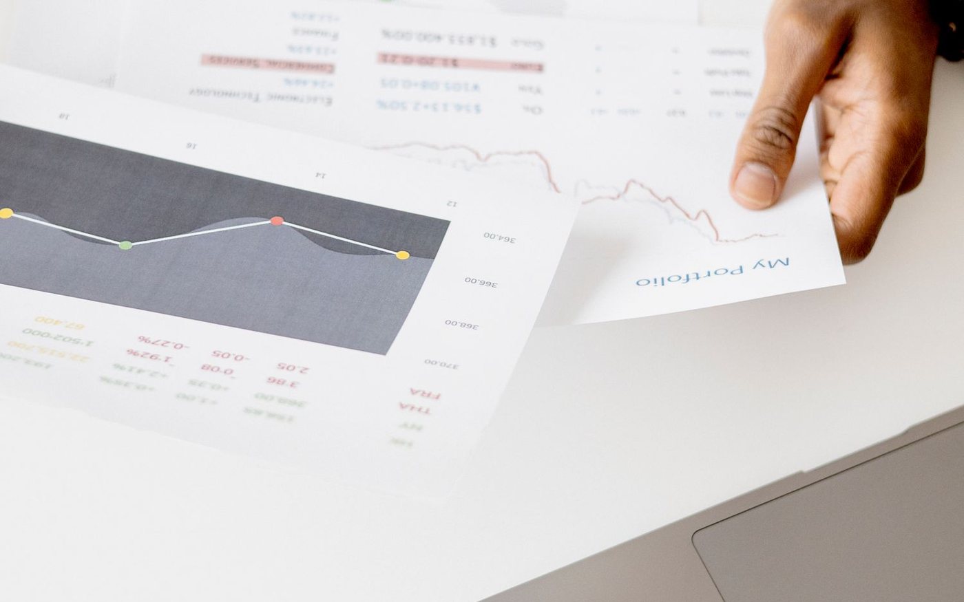 Market researcher reviewing charts and financial data during desk research and trend analysis.